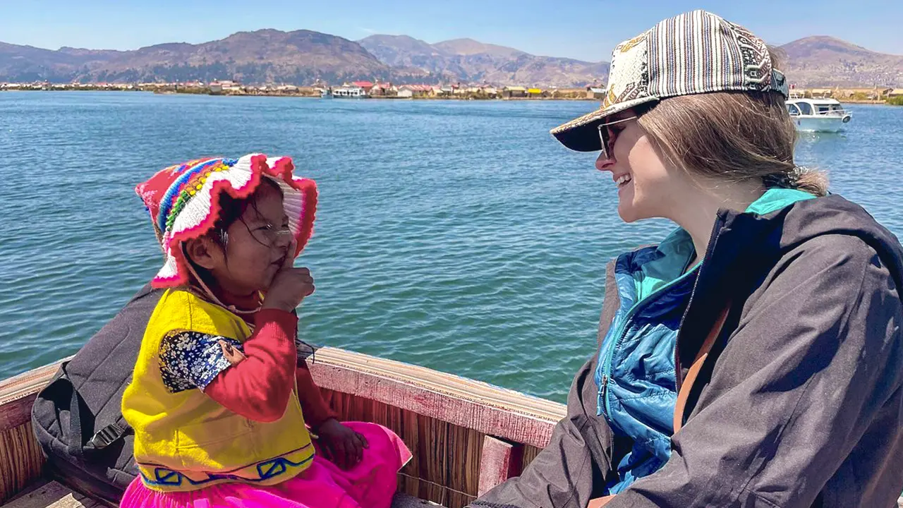 Tourist and Uros girl on the island
