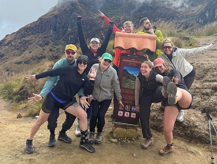 Hikers reaching Dead Woman’s Pass on the second day of the Inca Trail 4 Days 3 Nights, the highest point of the trek with breathtaking views of the Andes in Cusco, Peru