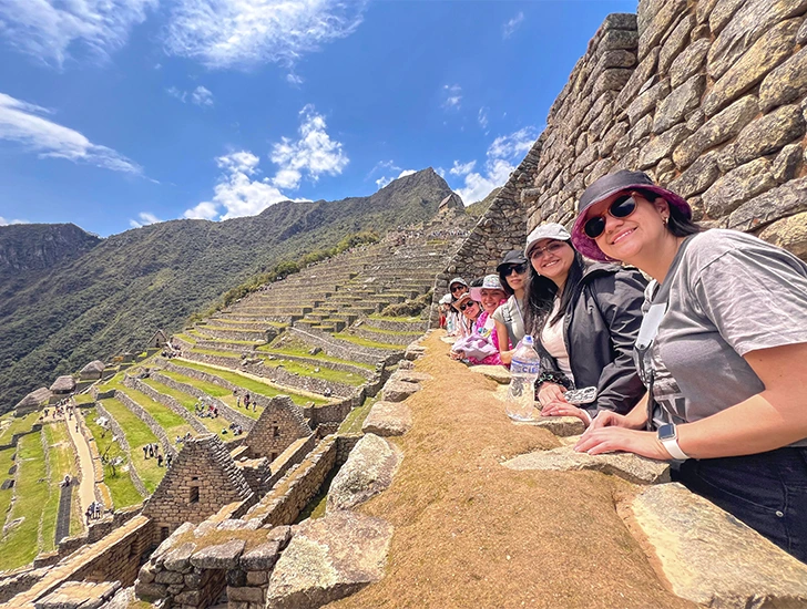 Tourists walking through Machu Picchu Circuit 2, enjoying the classic panoramic views of the Inca city and surrounding Andes during the Peru 7 Days 6 Nights tour.