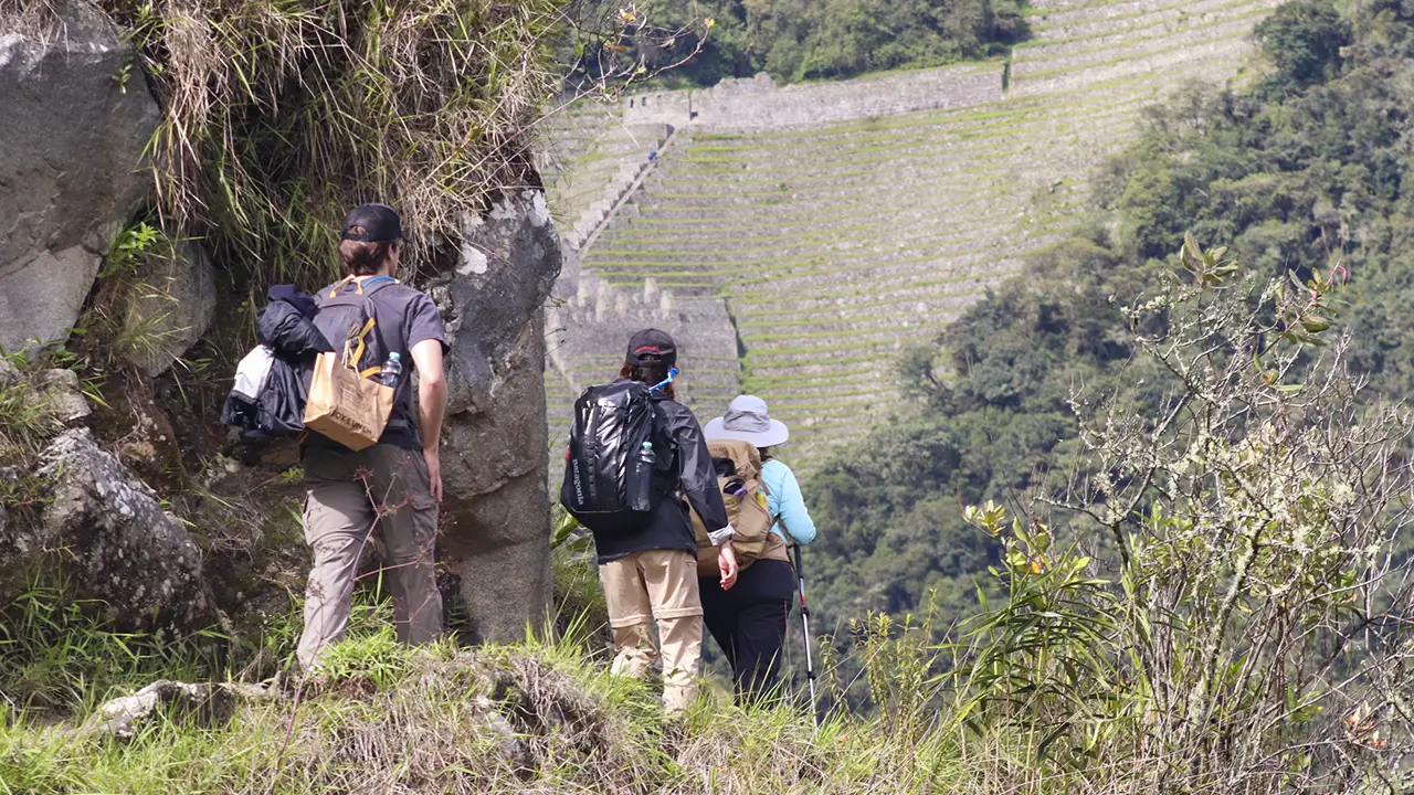Panoramic view of the Inca Trail with tourists walking