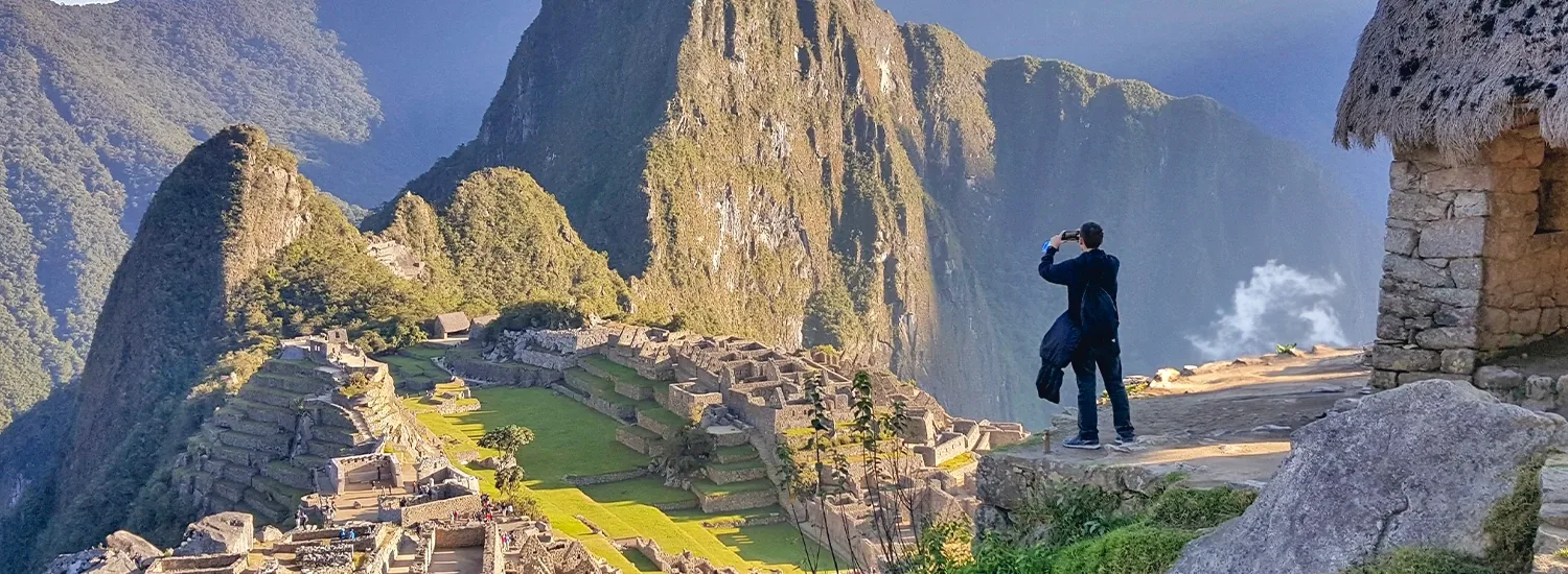 Panoramic view of Machu Picchu, the Inca citadel surrounded by Andean mountains.